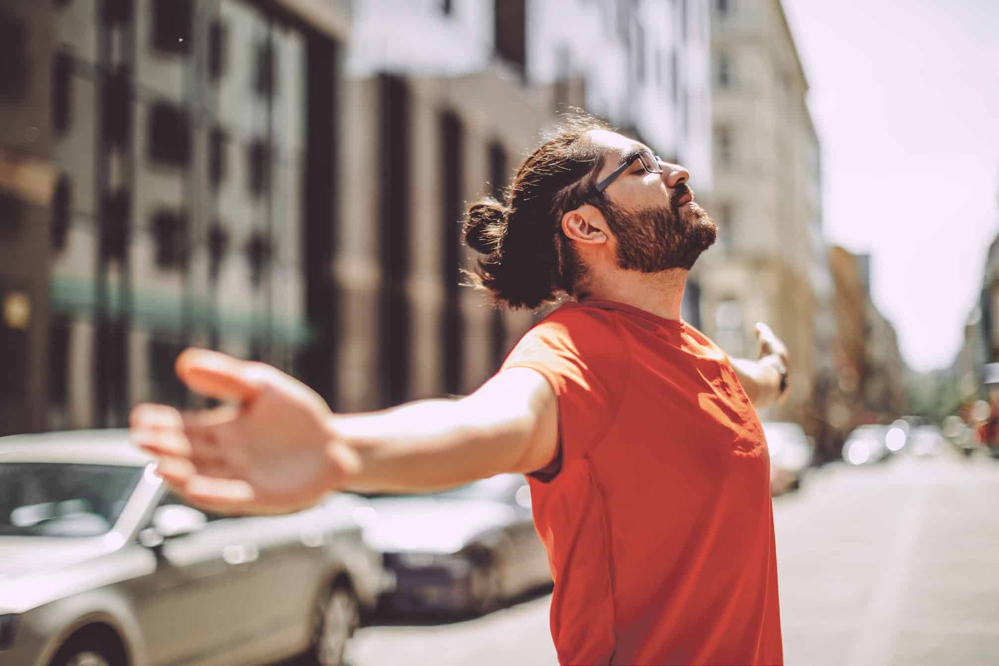 Man spreading arms on the street